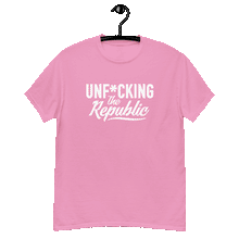 Load image into Gallery viewer, Bright pink classic tee shirt that says Unf*cking The Republic in white on the front and F*ck Milton Friedman in white on the back
