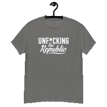 Load image into Gallery viewer, Charcoal gray colored classic tee shirt that says Unf*cking The Republic in white on the front and F*ck Milton Friedman in white on the back