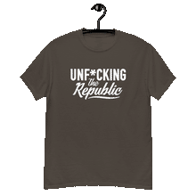 Load image into Gallery viewer, Chocolate brown colored classic tee shirt that says Unf*cking The Republic in white on the front and F*ck Milton Friedman in white on the back