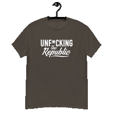 Load image into Gallery viewer, Chocolate colored classic tee shirt that says Unf*cking The Republic in white on the front and Meeting People Where They Are in white on the back