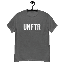 Load image into Gallery viewer, Heather gray colored classic tee shirt that says UNFTR in white on the front and F*ck Milton Friedman in white on the back