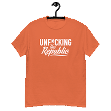 Load image into Gallery viewer, Orange classic tee shirt that says Unf*cking The Republic in white on the front and F*ck Milton Friedman in white on the back