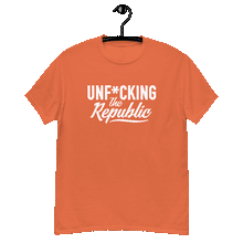 Load image into Gallery viewer, Orange classic tee shirt that says Unf*cking The Republic in white on the front and Meeting People Where They Are in white on the back