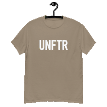 Load image into Gallery viewer, Sand colored classic tee shirt that says UNFTR in white on the front and F*ck Milton Friedman in white on the back