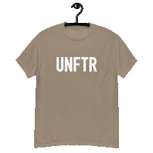 Load image into Gallery viewer, Sand colored classic tee shirt that says UNFTR in white on the front and Meeting People Where They Are in white on the back