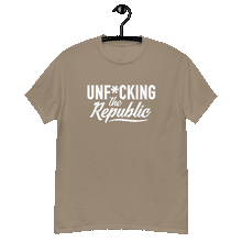 Load image into Gallery viewer, Sand colored classic tee shirt that says Unf*cking The Republic in white on the front and Meeting People Where They Are in white on the back