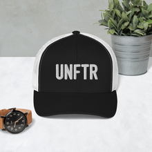 Load image into Gallery viewer, Black trucker hat with white side panels with white UNFTR logo embroidered on the front