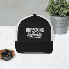 Load image into Gallery viewer, Black trucker hat with white side panels with white Unf*cking The Republic logo embroidered on the front