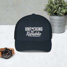 Load image into Gallery viewer, Navy trucker hat with navy side panels with white Unf*cking The Republic logo embroidered on the front