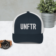 Load image into Gallery viewer, Navy trucker hat with white side panels with white UNFTR logo embroidered on the front