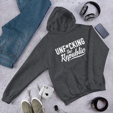 Load image into Gallery viewer, Heather gray hoodie with white logo that say Unf*cking The Republic.