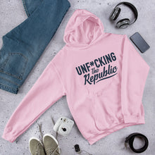 Load image into Gallery viewer, Light pink hoodie with navy logo that say Unf*cking The Republic.