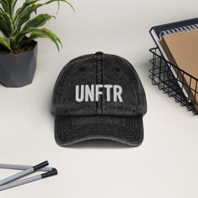 Load image into Gallery viewer, Black/Grey vintage wash dad cap with white UNFTR logo embroidered on the front.