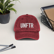 Load image into Gallery viewer, Maroon vintage wash dad cap with white UNFTR logo embroidered on the front.
