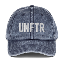 Load image into Gallery viewer, Blue denim-like vintage wash dad cap with white UNFTR logo embroidered on the front.