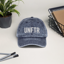 Load image into Gallery viewer, Blue denim-like vintage wash dad cap with white Unf*cking The Republic logo embroidered on the front.