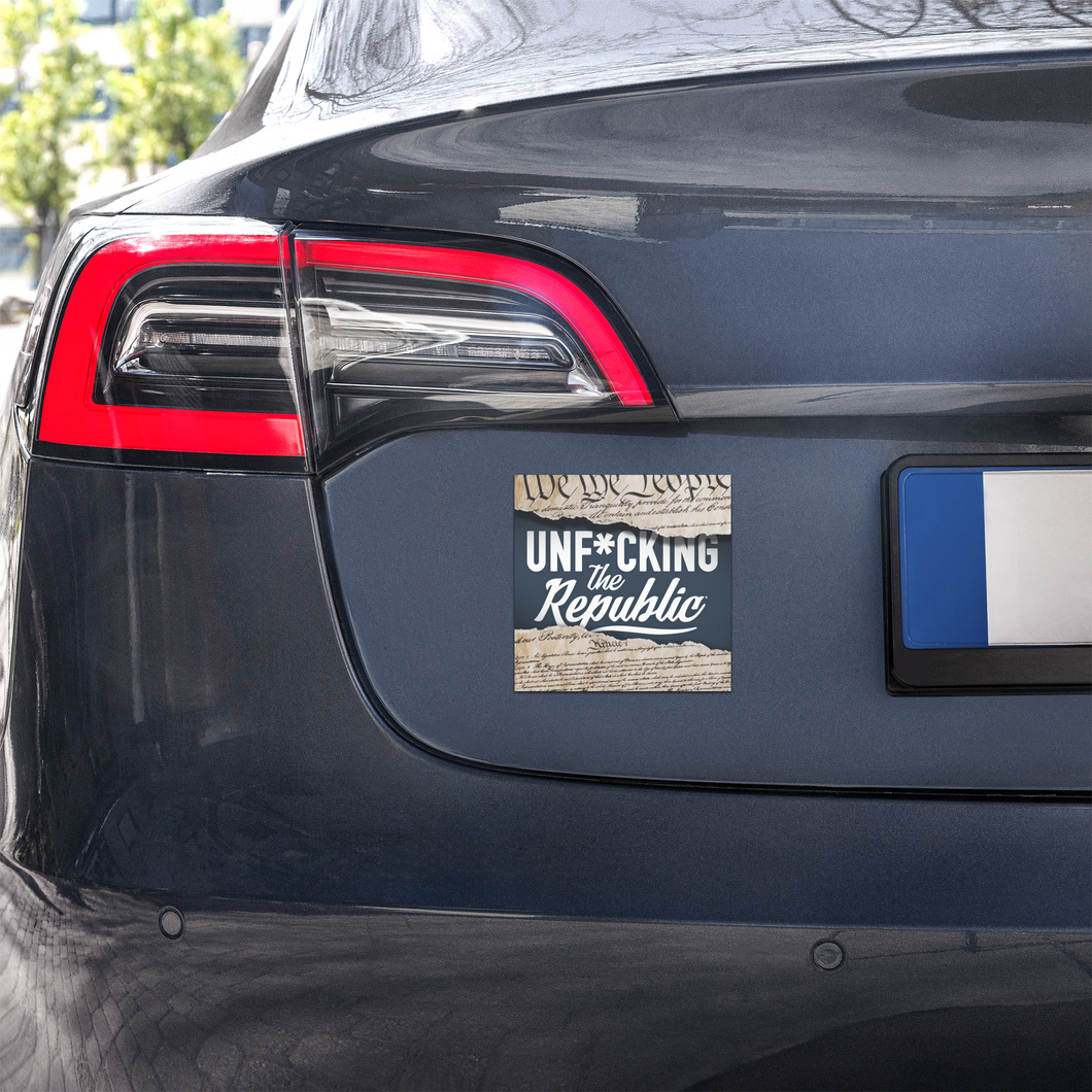 The trunk of a car featuring a square magnet with the Unf*cking The Republic podcast art on it. White text with a ripped constitution background.