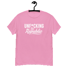 Load image into Gallery viewer, Bright pink classic tee shirt that says Unf*cking The Republic in white on the front and Meeting People Where They Are in white on the back
