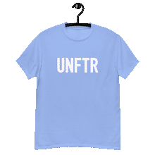 Load image into Gallery viewer, Carolina blue colored classic tee shirt that says UNFTR in white on the front and Meeting People Where They Are in white on the back
