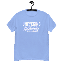 Load image into Gallery viewer, Carolina blue colored classic tee shirt that says Unf*cking The Republic in white on the front and F*ck Milton Friedman in white on the back
