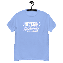 Load image into Gallery viewer, Carolina blue colored classic tee shirt that says Unf*cking The Republic in white on the front and Meeting People Where They Are in white on the back
