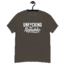 Load image into Gallery viewer, Chocolate colored classic tee shirt that says Unf*cking The Republic in white on the front and Meeting People Where They Are in white on the back
