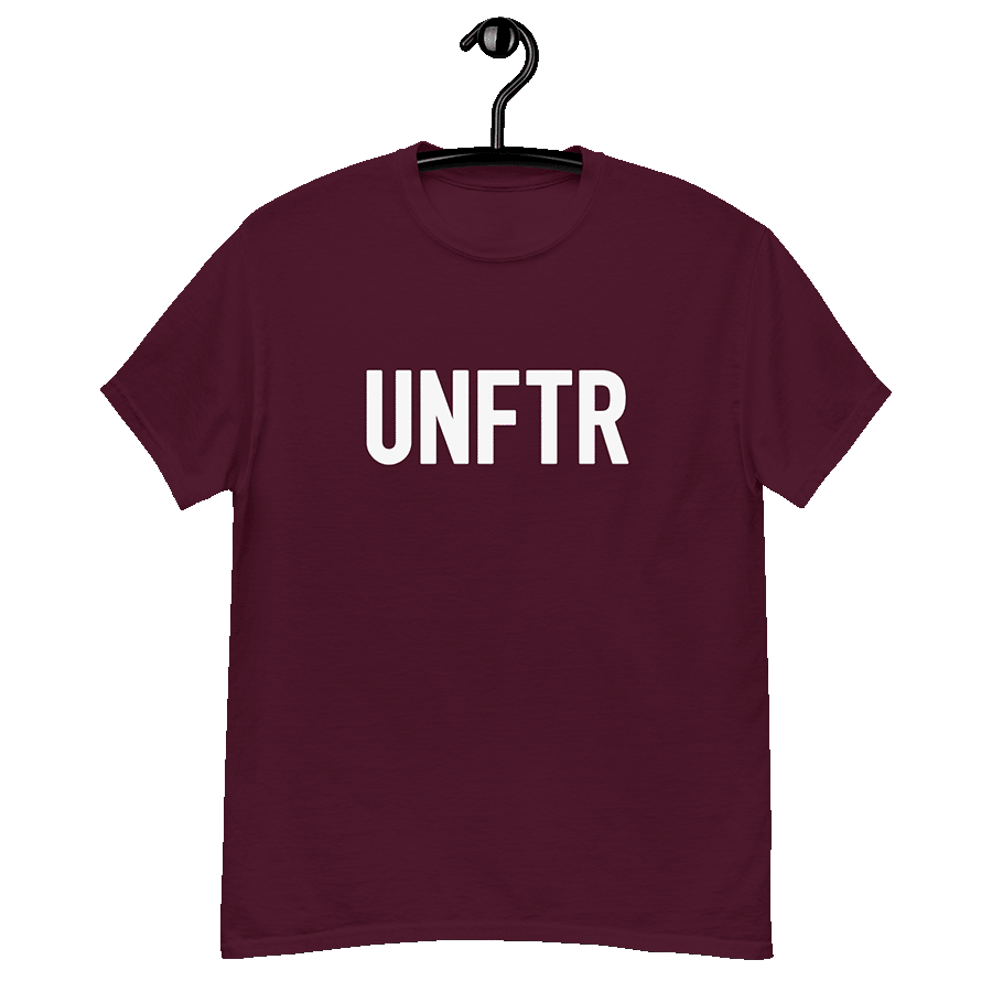 Maroon classic tee shirt that says UNFTR in white on the front and F*ck Milton Friedman in white on the back