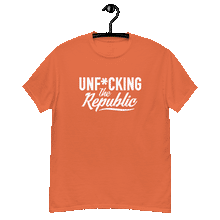 Load image into Gallery viewer, Orange classic tee shirt that says Unf*cking The Republic in white on the front and F*ck Milton Friedman in white on the back
