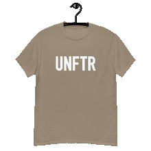 Load image into Gallery viewer, Sand colored classic tee shirt that says UNFTR in white on the front and F*ck Milton Friedman in white on the back

