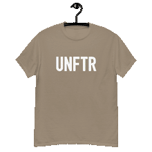 Load image into Gallery viewer, Sand colored classic tee shirt that says UNFTR in white on the front and Meeting People Where They Are in white on the back
