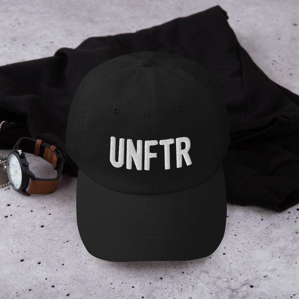 Black dad hat with white embroidered UNFTR logo