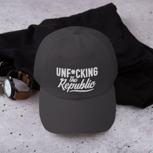 Load image into Gallery viewer, Charcoal dad hat with white embroidered Unf*cking The Republic logo
