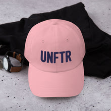 Load image into Gallery viewer, Light pink dad hat with navy embroidered UNFTR logo
