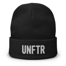 Load image into Gallery viewer, Black cuffed beanie with white embroidered logo that says ‘UNFTR’
