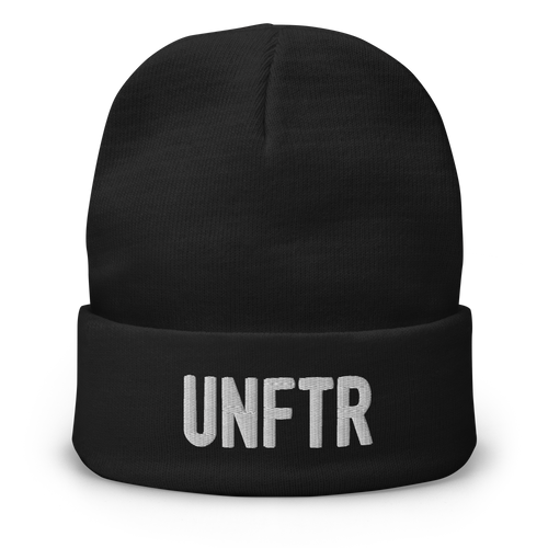Black cuffed beanie with white embroidered logo that says ‘UNFTR’