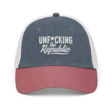 Load image into Gallery viewer, Blue, red and white trucker hat with white embroidered logo that says &#39;Unf*cking The Republic.&#39;
