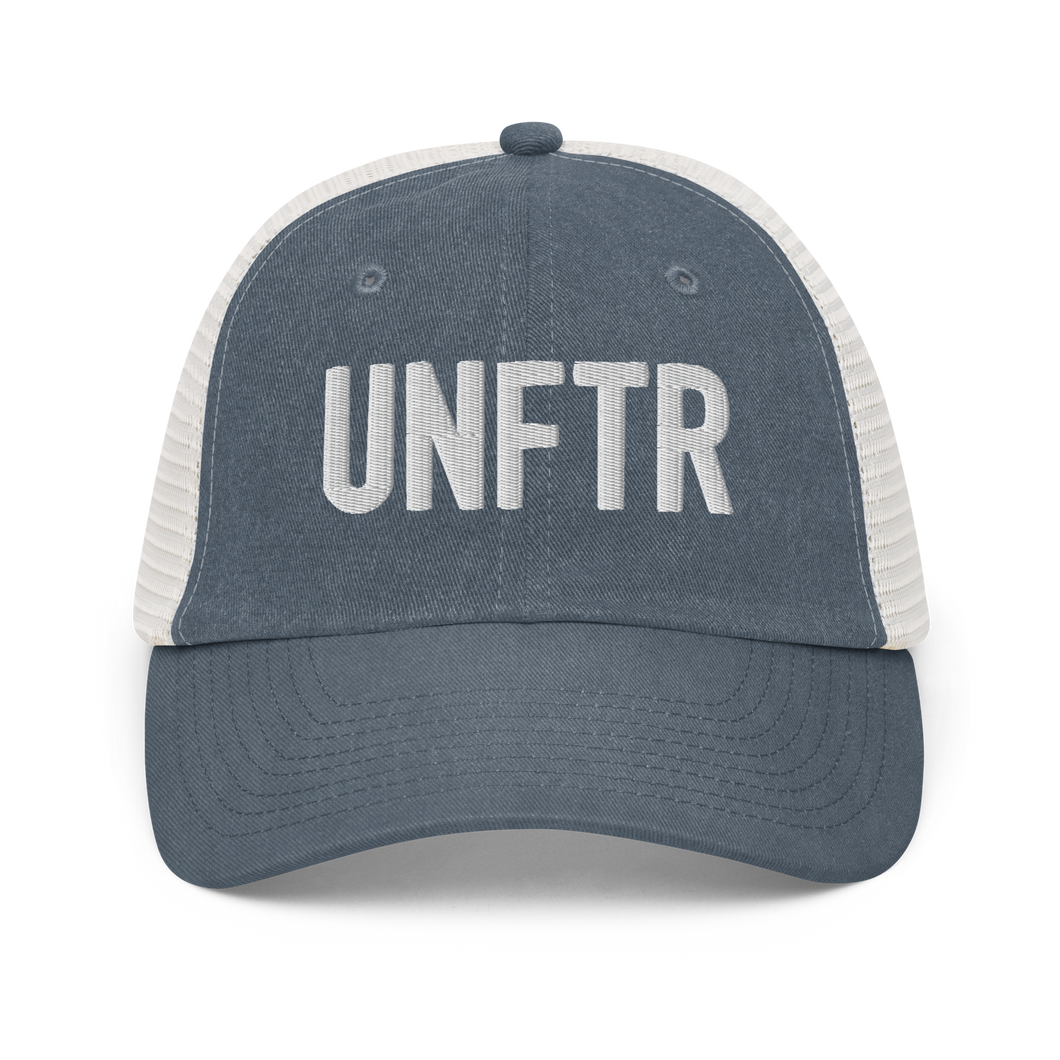 Blue and white trucker hat with white embroidered logo that says 'UNFTR.'