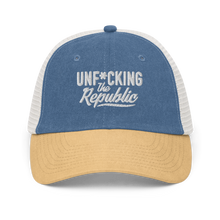 Load image into Gallery viewer, Blue, tan and white trucker hat with white embroidered logo that says &#39;Unf*cking The Republic.&#39;
