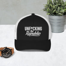 Load image into Gallery viewer, Black trucker hat with white side panels with white Unf*cking The Republic logo embroidered on the front
