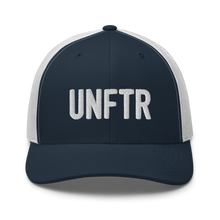 Load image into Gallery viewer, Navy trucker hat with white panels and white embroidery that says UNFTR.
