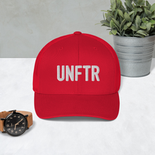 Load image into Gallery viewer, Red trucker hat with Red side panels with white UNFTR logo embroidered on the front
