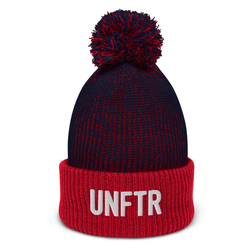 Speckled navy and red pom-pom beanie with white embroidered logo that says ‘UNFTR’
