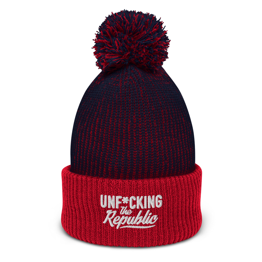 Speckled navy and red pom-pom beanie with white embroidered logo that says ‘Unf*cking The Republic’