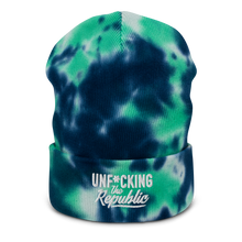 Load image into Gallery viewer, Navy, turquoise and white beanie with embroidered white logo that says ‘Unf*cking The Republic’
