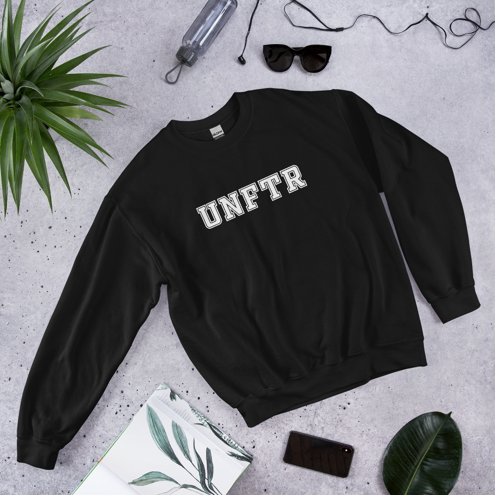 Black crew neck with white block letters that say UNFTR.