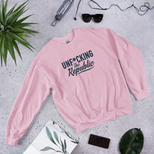 Load image into Gallery viewer, Light pink crew neck with navy logo that say Unf*cking The Republic.
