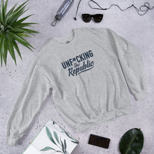 Load image into Gallery viewer, Light heather gray crew neck with navy logo that say Unf*cking The Republic.
