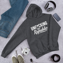 Load image into Gallery viewer, Heather gray hoodie with white logo that say Unf*cking The Republic.
