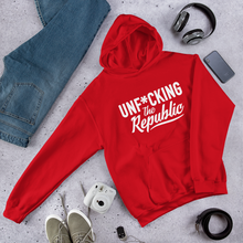 Load image into Gallery viewer, Red hoodie with white logo that say Unf*cking The Republic.
